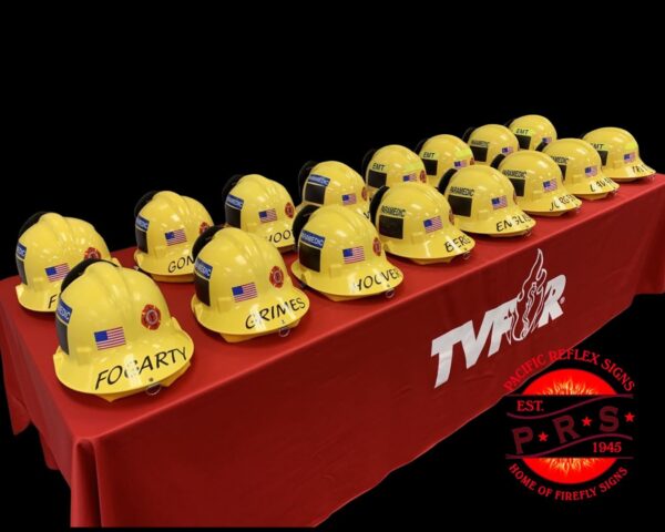 A red table topped with yellow fire helmets.