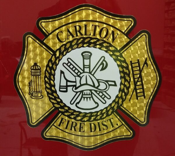 Carlton Fire District emblem with fire tools.